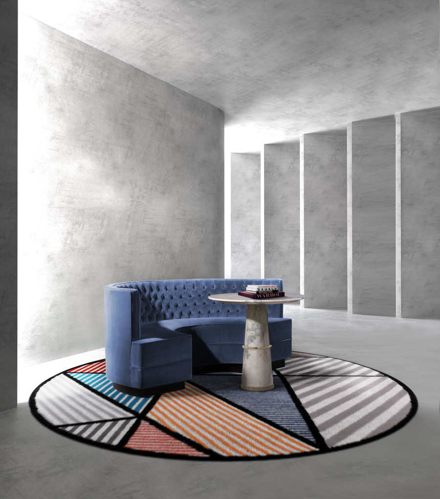 blue and grey hallway design with round sofa and round rug