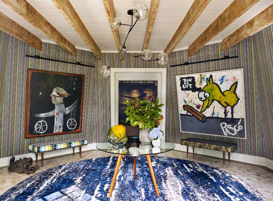 Fox-Nahem Associates, a colorful entryway with a blue rug and artistic wall paintings