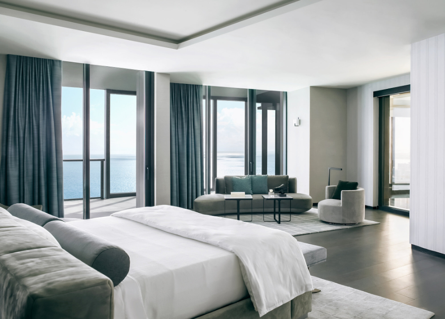 High-end Residential Projects by Michael Wolk. Oceanfront Penthouse. Bedroom in neutral tones and a lounge area.