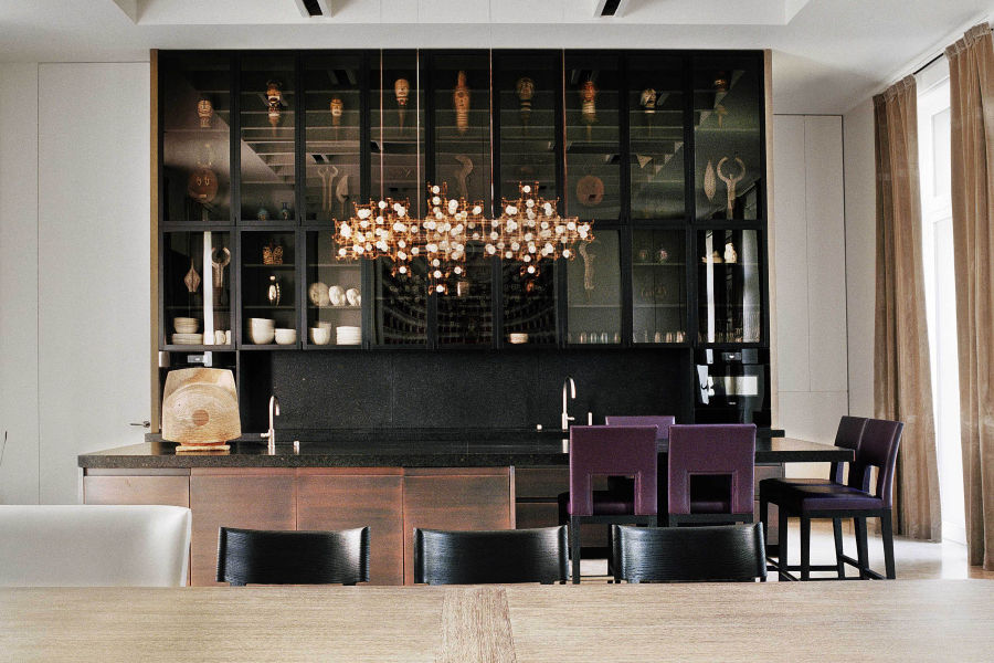 Modern Interior Design Projects by Christian Liaigre. Modern Kitchen with dark tones and black chairs.