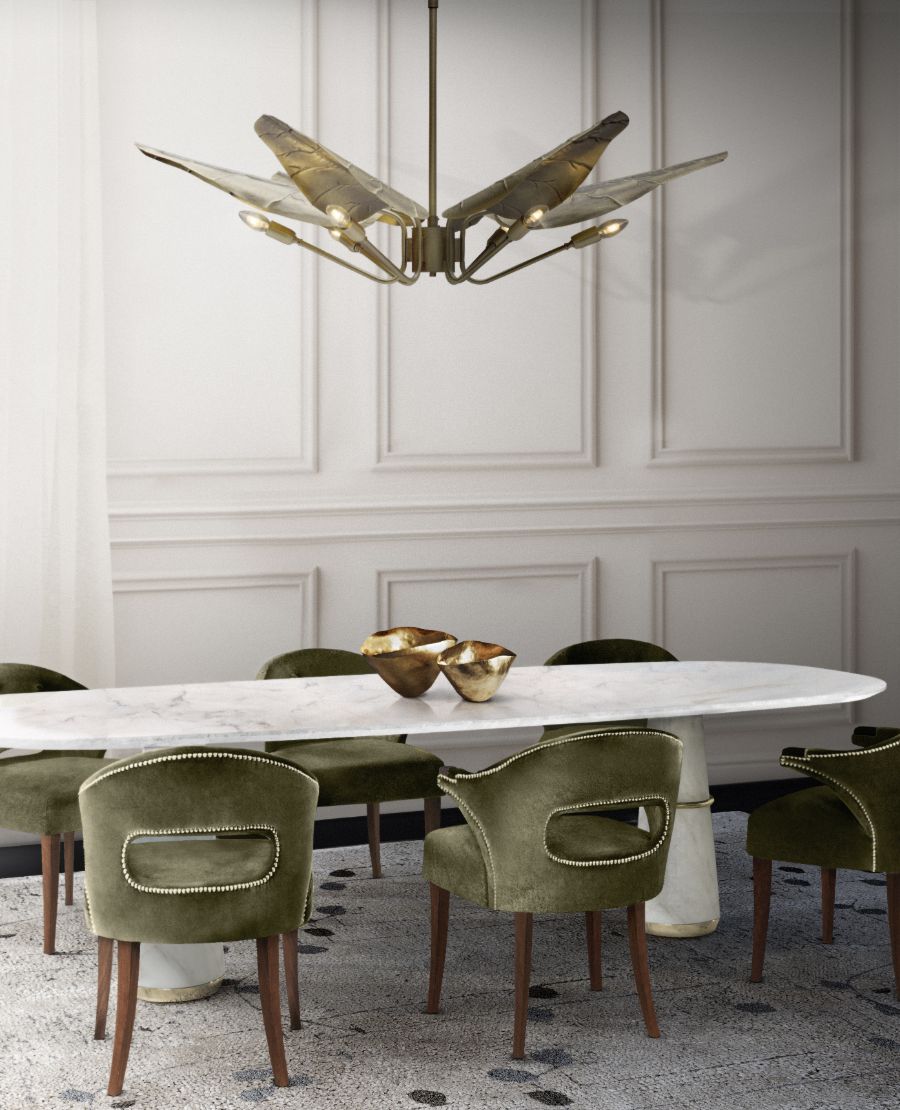 modern dining room with white oval dining table and green velvet dining chairs