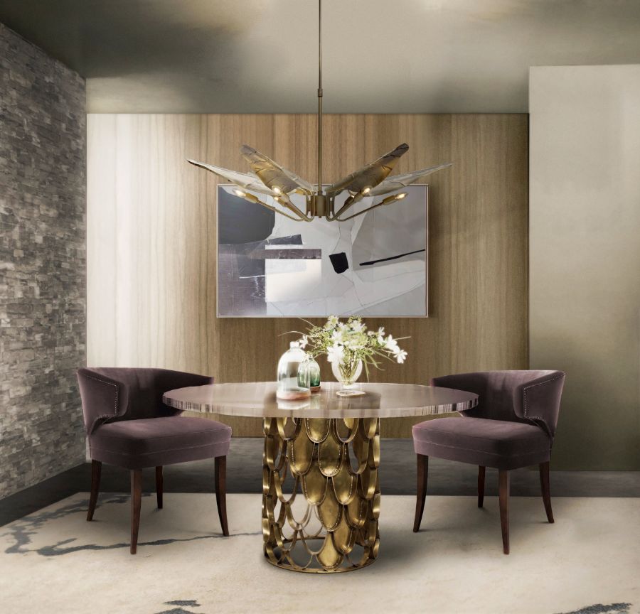 dining room with plum velvet dining chairs and round brass dining table
