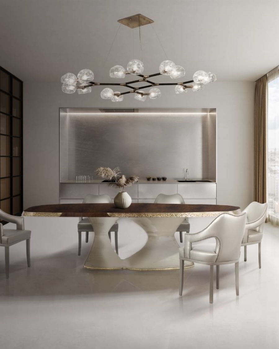 The stunning HORUS II Suspension Light is the best statement to make in modern dining room decor. Featuring a structure in matte black lacquered brass and shades in matte brass, this chandelier is perfect for creating a grand reveal over a fierce PLATEAU I Dining Table with a top in walnut root veneer with a matte varnish and details in matte hammered brushed aged brass and over Nº20 Dining Chairs, fully upholstered in twill with a nail head trim that adds subtle sophistication.