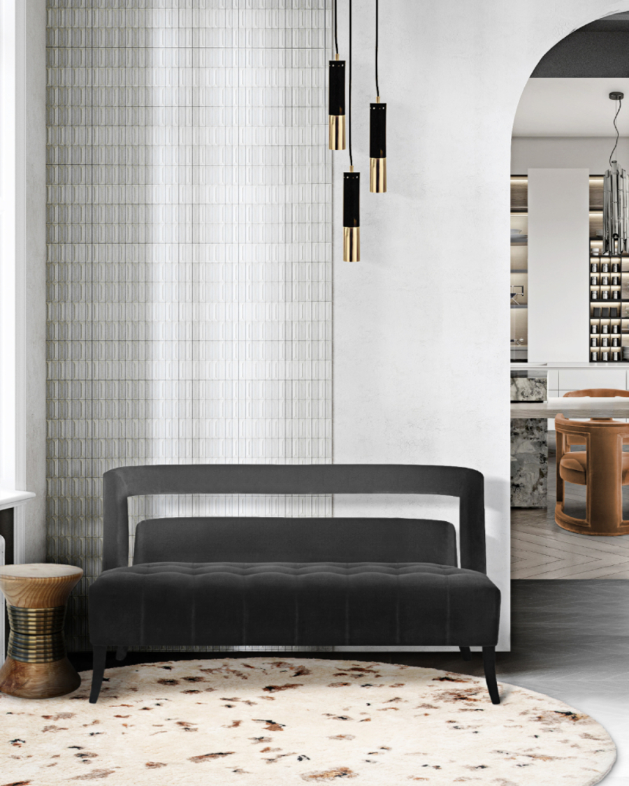 This living room corner has a modern design and products that are enhanced by the natural light coming in through the windows. NAJ 2 Seat Sofa, fully upholstered in cotton velvet with nickeled nails and inspired in one of the most important discoveries in the twentieth century, the Naj Tunich, is the main product of this room. It is accompanied by the PADAUNG Stool and the Rug'Society OSLO Rug to make this a cosier and comfortable room.
