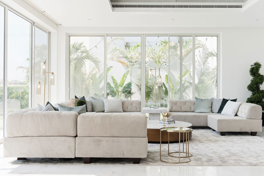 A living room with a bespoke corner sofa and a center table.