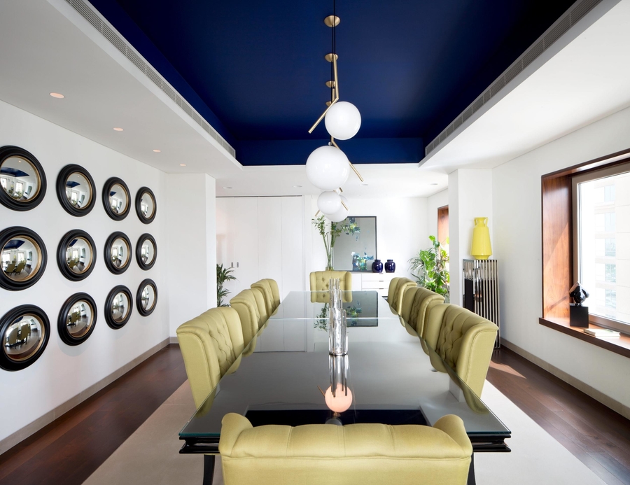 A dining room with bespoke dining chairs and a bespoke table, completed with a rug.