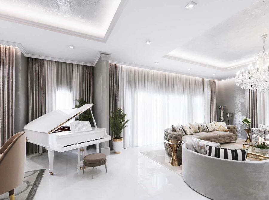 White living room furnished with some bespoke upholtery and a white piano.