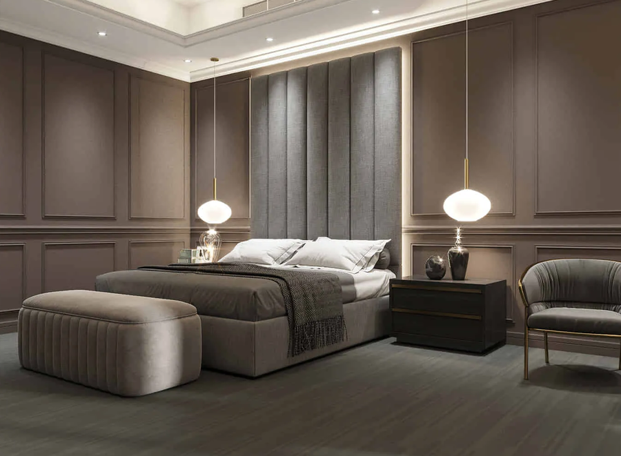 A hotel room furnished with a custom made bed accompanied with some bespoke upholstery.