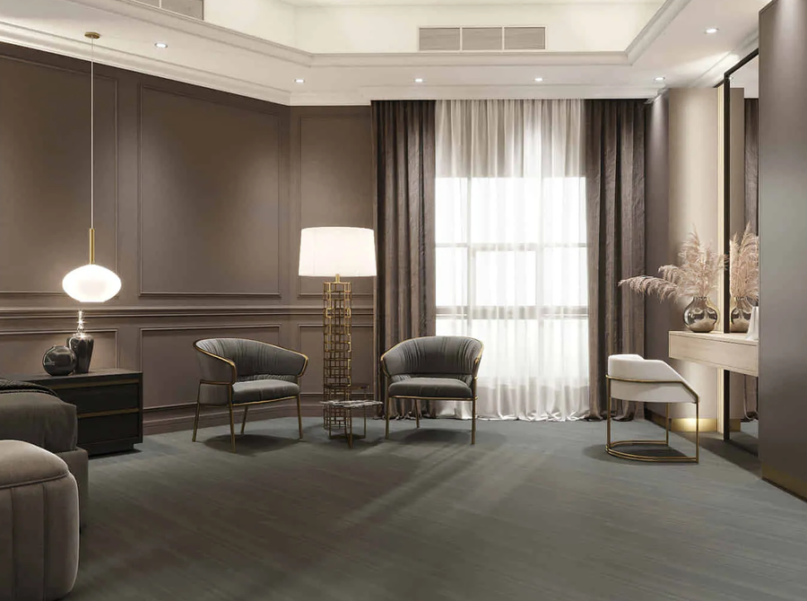A hotel room furnished with a custom floor lamp and some bespoke armchairs.