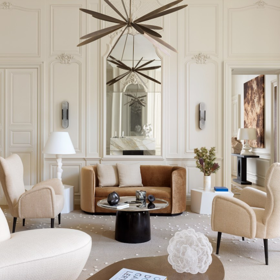 Damien Langlois-Meurinne presents Modern Interior Designs. Ile st louis project with view for the living room. Living room with neutral colours, two classics armchair and a curved sofa. To complete the look we see a modern centre table and a modern suspension light