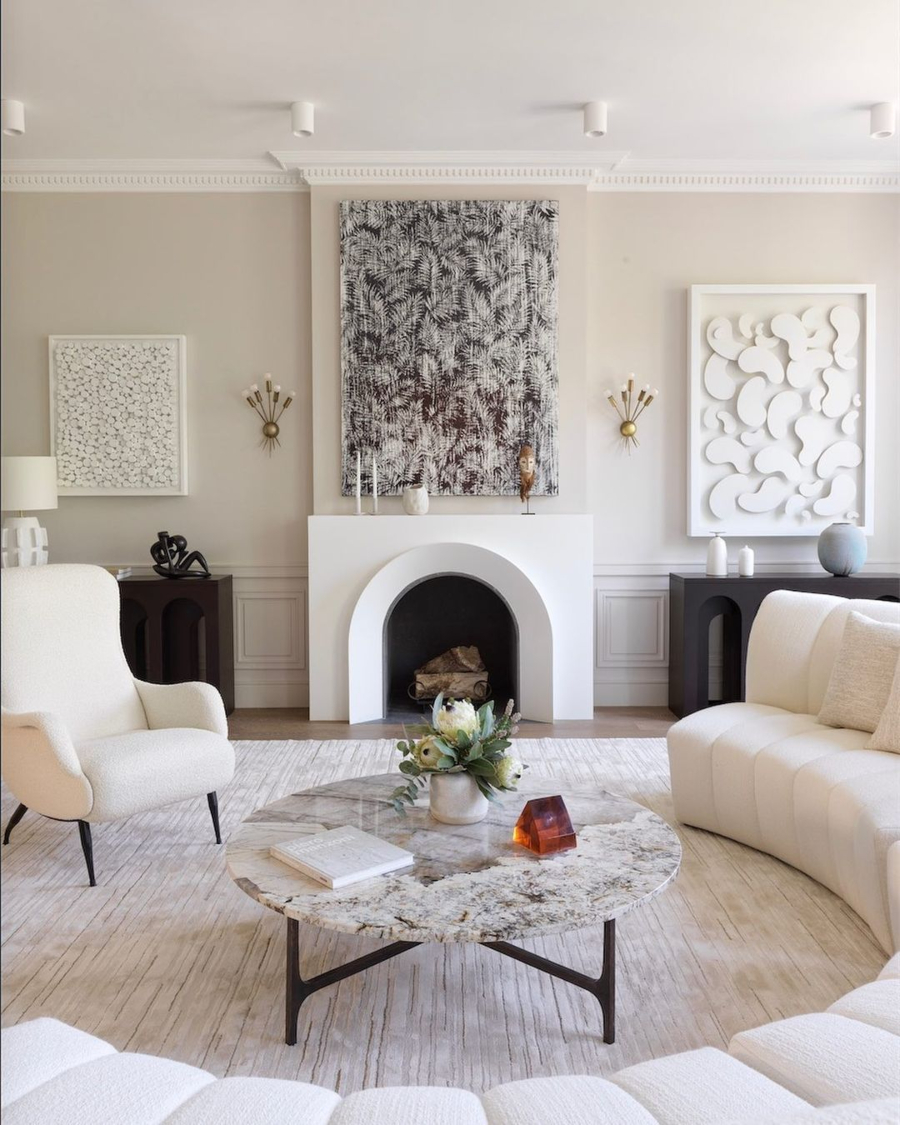 Damien Langlois-Meurinne presents Modern Interior Designs. Living room with large curved white sofa, an amrchair and a marble centre table