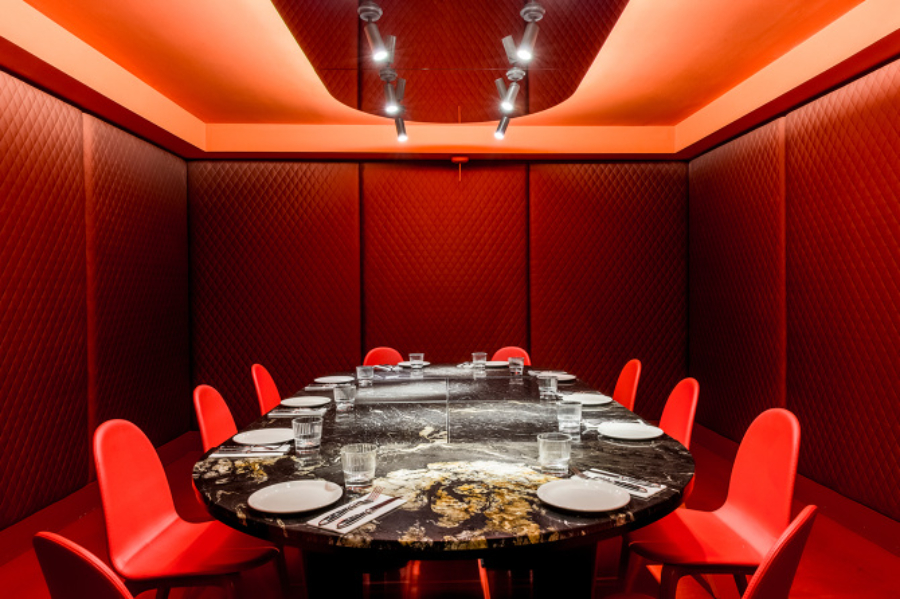black marble dining table and red dining chairs