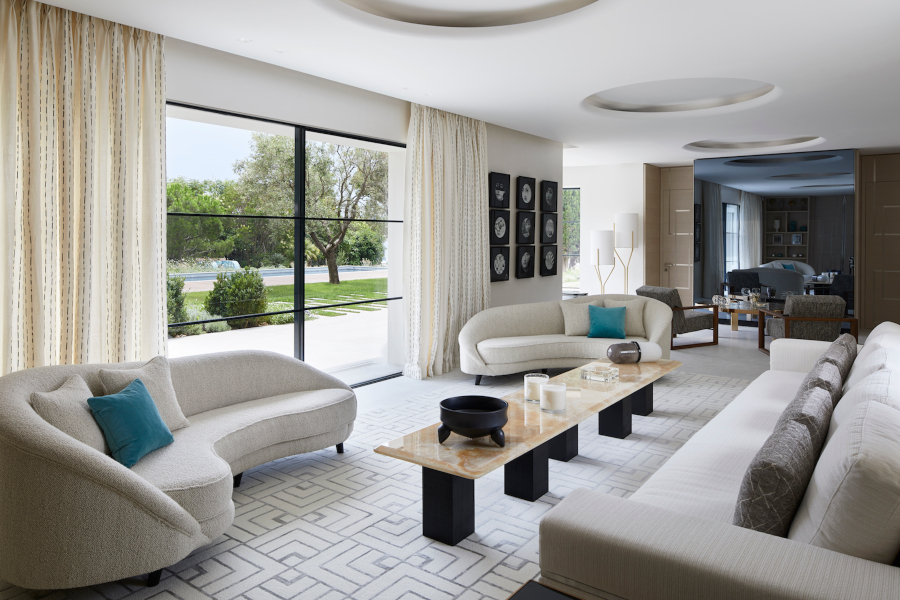 Modern Interior Design by Stéphanie Coutas. Contemporary living room with three sofas, long coffee table and garden view