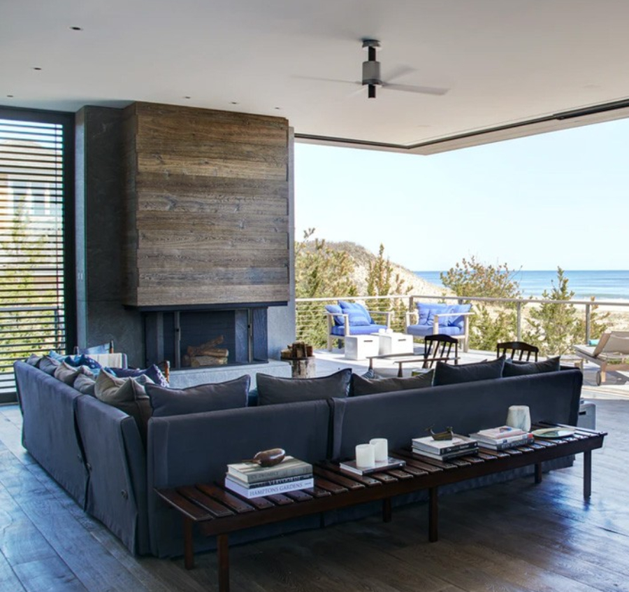 Interior Design Ideas with Yabu Pushelberg. This living room featured a big blue sofa and also a fireplace in wood all to the ceiling. 