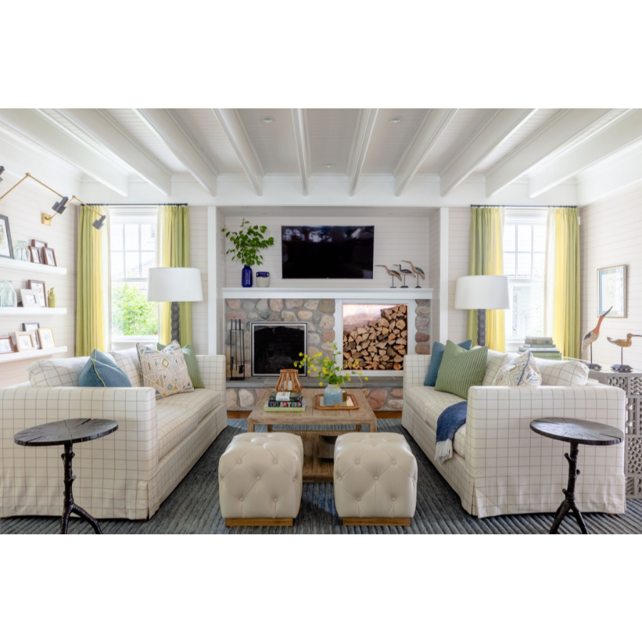 Modern Interior Design: This is a big living room, you can see a fireplace, white sofas, a wooden table, a big lounge rug, and white floor lights