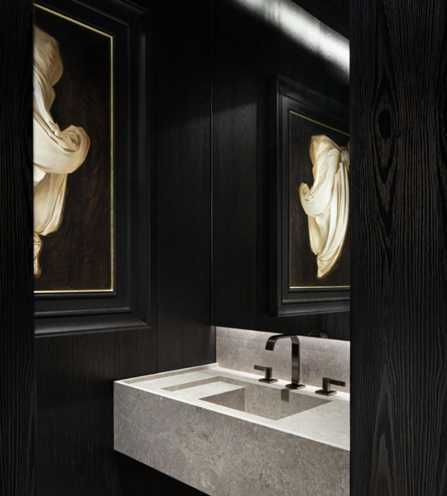 The Best Interior Design Ideas By Audax. This luxurious bathroom in black walls has a golden paiting and a grey marble sink. 