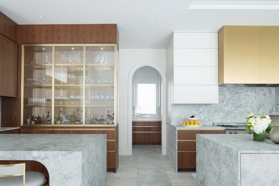 The Best Interior Design Ideas By Audax. This modern contemporary kitchen has wood cabinets with golden feautures and grey marble islands. 