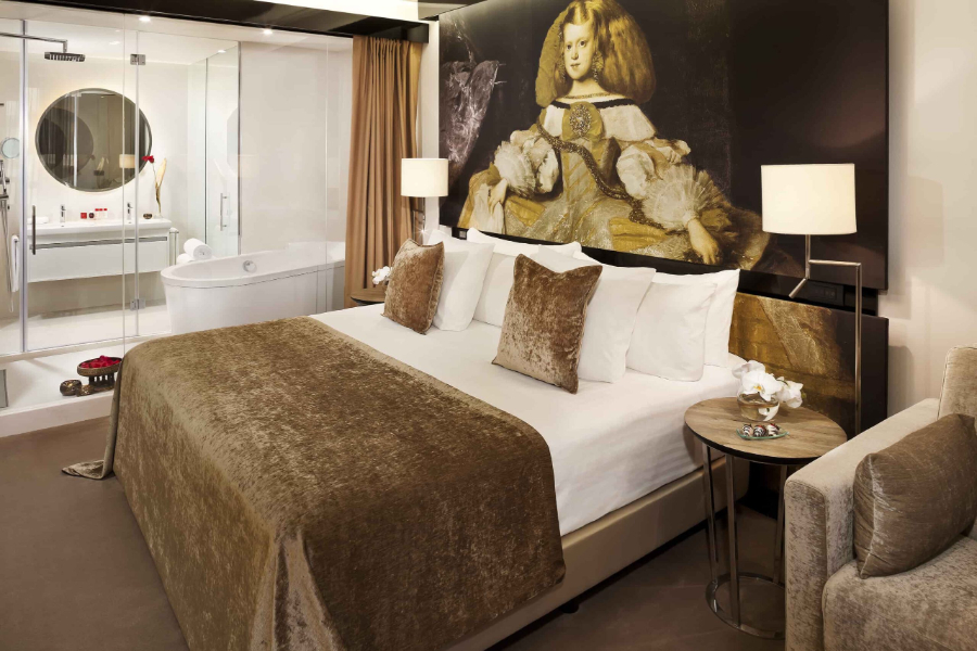 bedroom by Proffetional Finishing Design with golden head board and brown sofa and wooden bedside tables