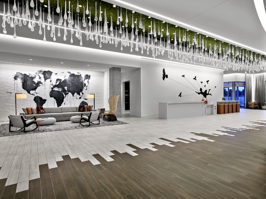 Rottet Studio: Architecture And Design In Texas. A living area with white pendants on the ceiling. The floor in wood, is half white, half brown.