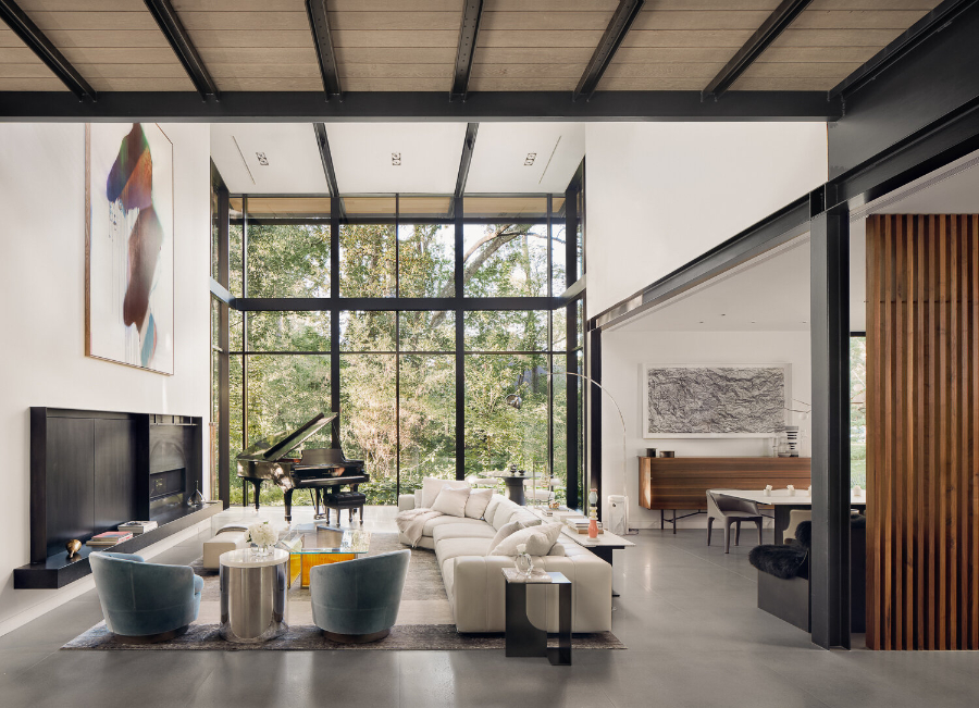 Rottet Studio: Architecture And Design In Texas. A wide living room with a huge white sofa and a center table. There's also a side table with two arm chairs.