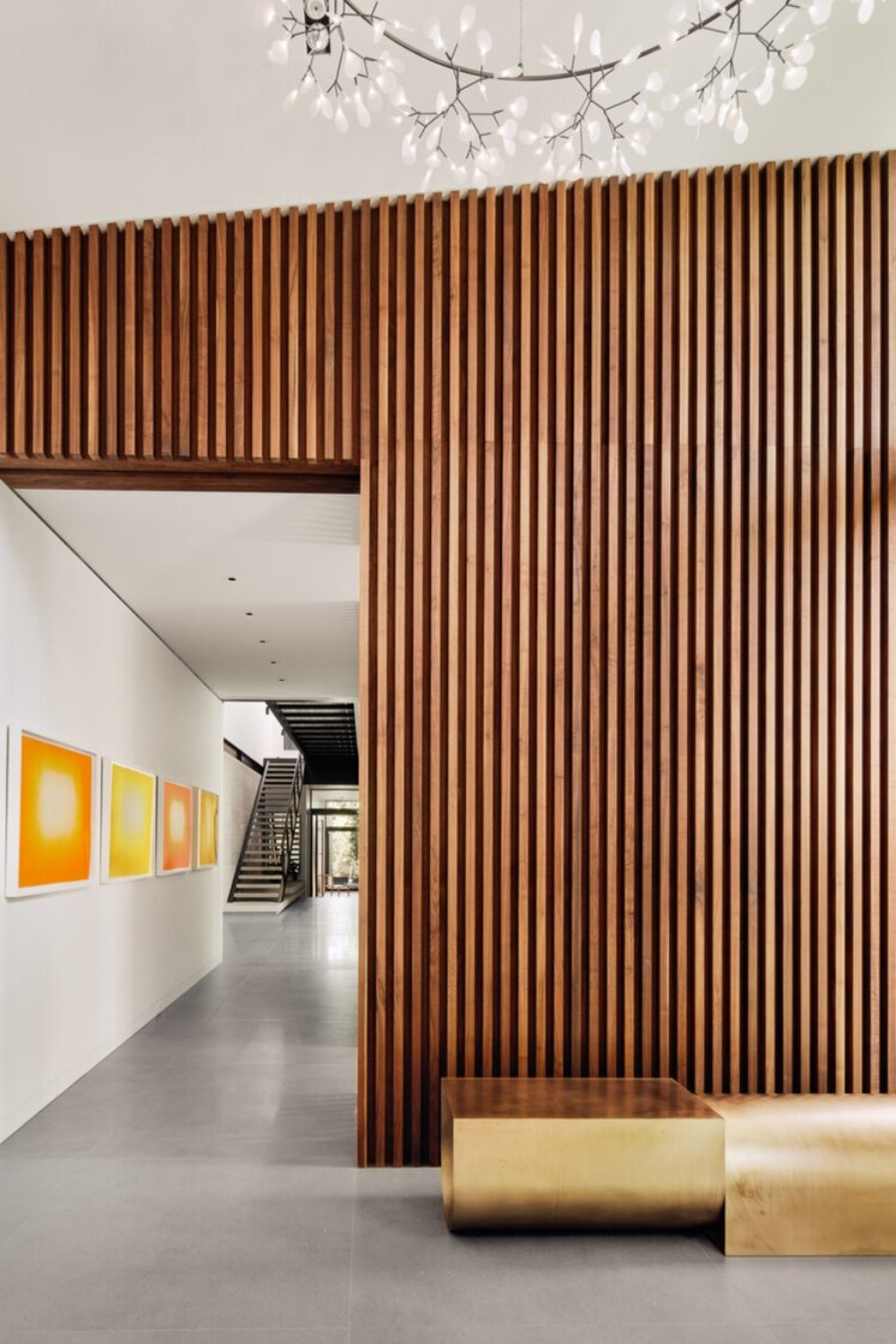 Rottet Studio: Architecture And Design In Texas. A hallway with a beautiful suspension light that resembles a flower.