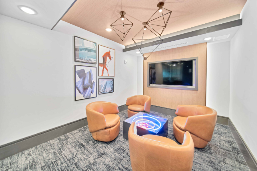 SJL Design Group: Interior Design In Texas. A small living room with a center table and four single sofas.
