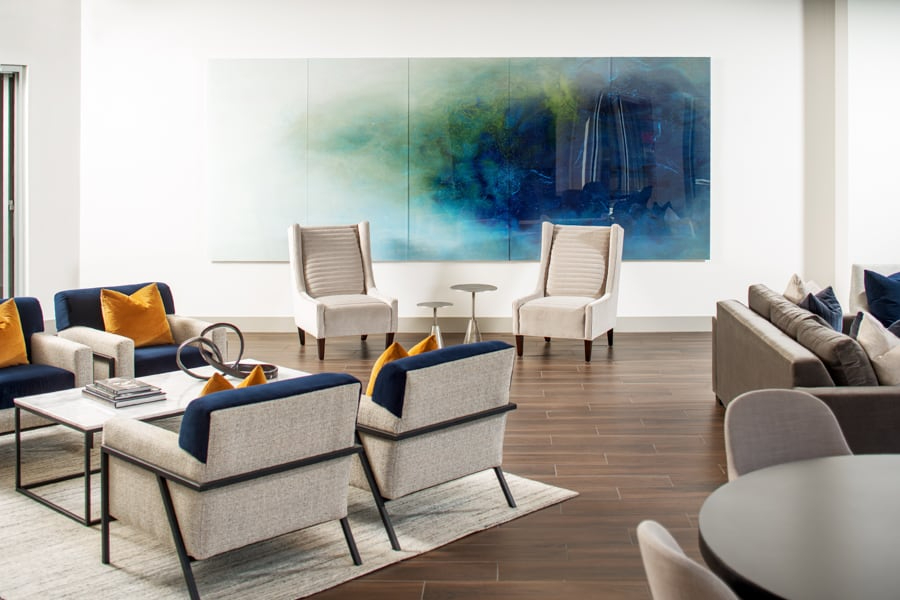 SJL Design Group: Interior Design In Texas. In this wide living area there is a sofa corner, a reading corner, a lounge area with a center table and four armschairs, and a table with some chairs.